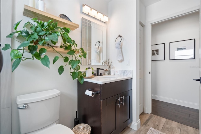 2182 Trevor Rd, Palm Harbor, FL 34683 - bathroom with wood finished floors and vanity