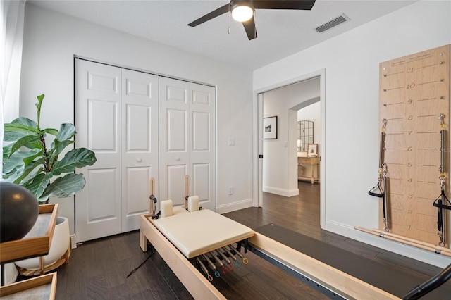 2182 Trevor Rd, Palm Harbor, FL 34683 - bedroom featuring dark wood-type flooring, a closet, arched walkways, and a ceiling fan
