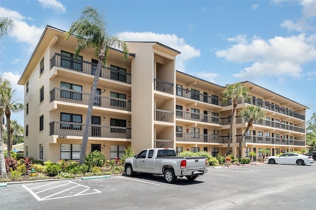 635 30th Ave W Unit F309, Bradenton, FL 34205 - view of apartment building / complex featuring uncovered parking
