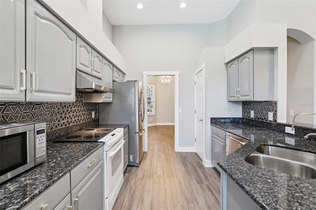 19113 Golden Cacoon Pl, Lutz, FL 33558 - kitchen featuring white range with electric stovetop, under cabinet range hood, stainless steel microwave, gray cabinets, and light wood-type flooring