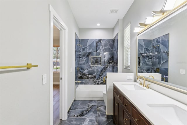 19113 Golden Cacoon Pl, Lutz, FL 33558 - full bathroom featuring marble tiled floors, plenty of natural light, a tub to relax in, double vanity, and recessed lighting