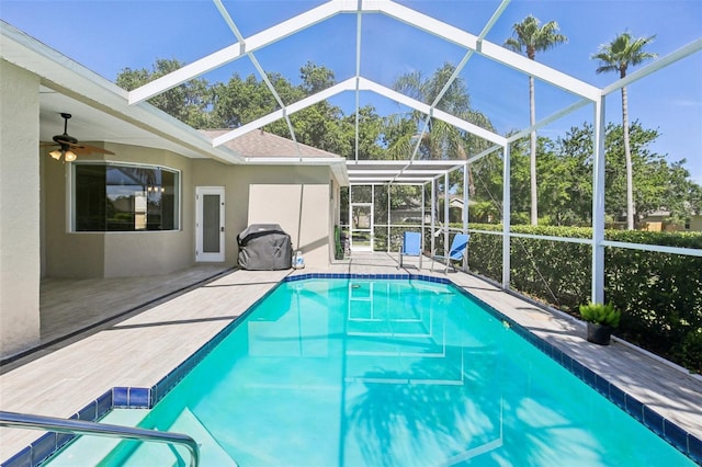 19113 Golden Cacoon Pl, Lutz, FL 33558 - swimming pool with glass enclosure, a patio, and ceiling fan
