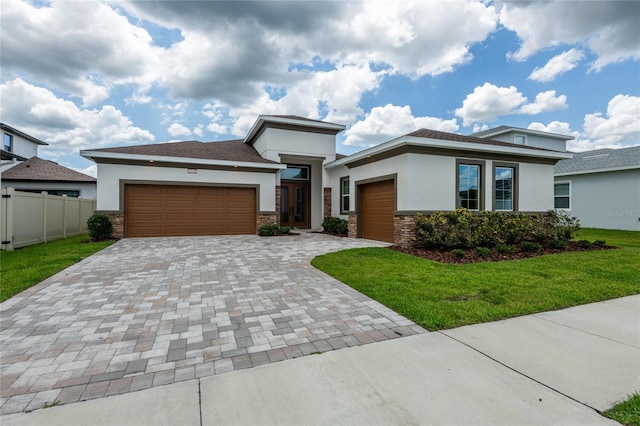 8749 Drummer Plank Dr, Wesley Chapel, FL 33545 - prairie-style home featuring stucco siding, an attached garage, decorative driveway, and stone siding