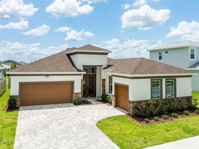 8749 Drummer Plank Dr, Wesley Chapel, FL 33545 - view of front of home with stucco siding, a garage, stone siding, and a shingled roof