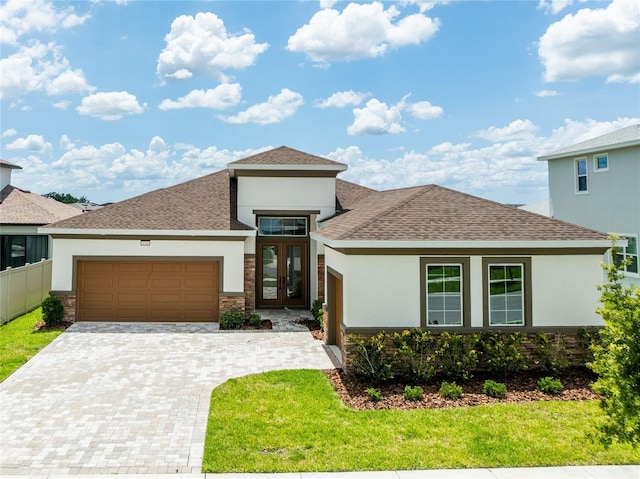 8749 Drummer Plank Dr, Wesley Chapel, FL 33545 - view of front of home featuring stucco siding, an attached garage, decorative driveway, a shingled roof, and stone siding