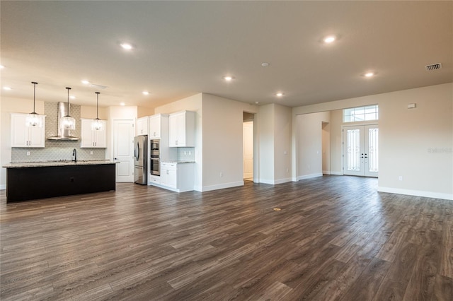 8749 Drummer Plank Dr, Wesley Chapel, FL 33545 - unfurnished living room featuring recessed lighting and dark wood finished floors