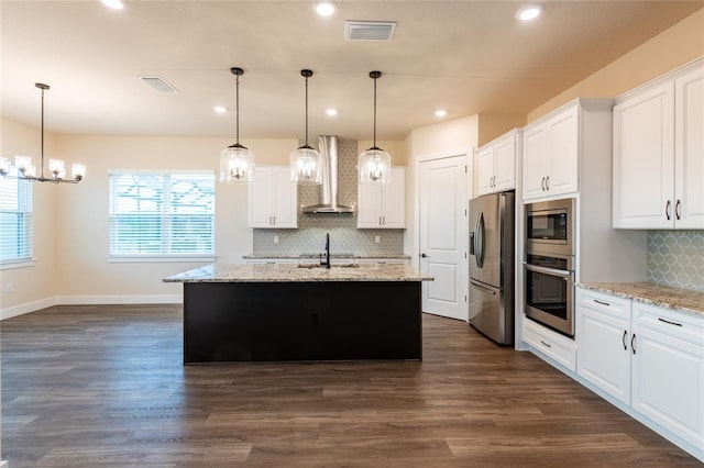 8749 Drummer Plank Dr, Wesley Chapel, FL 33545 - kitchen featuring stainless steel appliances, wall chimney range hood, tasteful backsplash, white cabinetry, and healthy amount of natural light