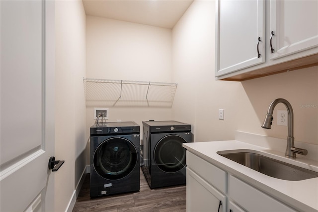 8749 Drummer Plank Dr, Wesley Chapel, FL 33545 - laundry room featuring separate washer and dryer, wood finished floors, and cabinet space
