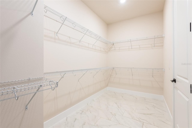 8749 Drummer Plank Dr, Wesley Chapel, FL 33545 - walk in closet featuring light marble finish flooring