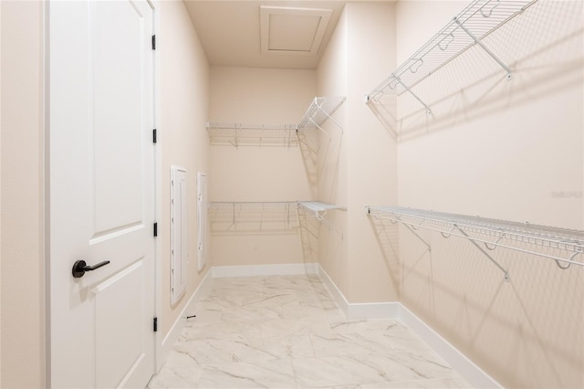 8749 Drummer Plank Dr, Wesley Chapel, FL 33545 - walk in closet with light marble finish floors and attic access