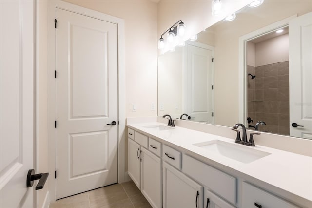 8749 Drummer Plank Dr, Wesley Chapel, FL 33545 - bathroom featuring double vanity, tiled shower, and tile patterned floors