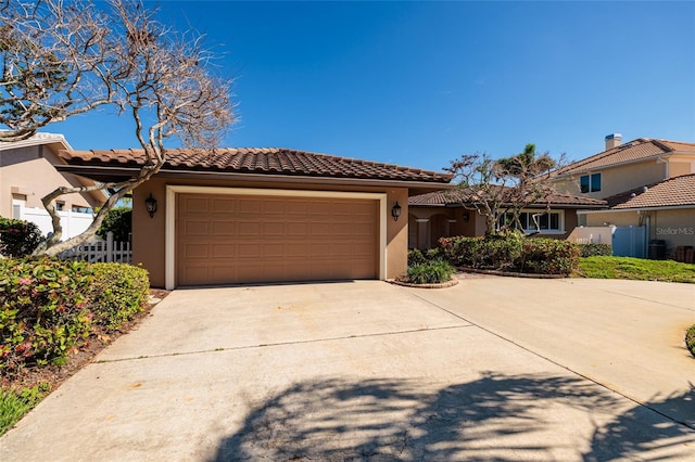 208 Bath Club Blvd N, North Redington Beach, FL 33708 - view of front facade with an attached garage, concrete driveway, stucco siding, and a tiled roof