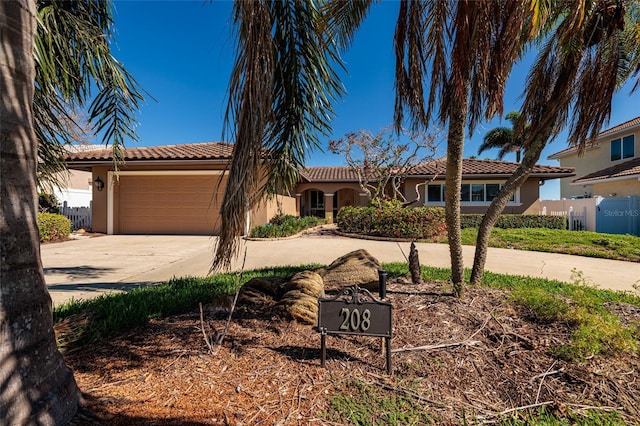 208 Bath Club Blvd N, North Redington Beach, FL 33708 - mediterranean / spanish-style home with stucco siding, concrete driveway, a tiled roof, and a garage
