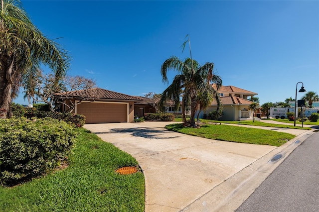 208 Bath Club Blvd N, North Redington Beach, FL 33708 - view of front of property with concrete driveway, a garage, a front yard, stucco siding, and a tile roof