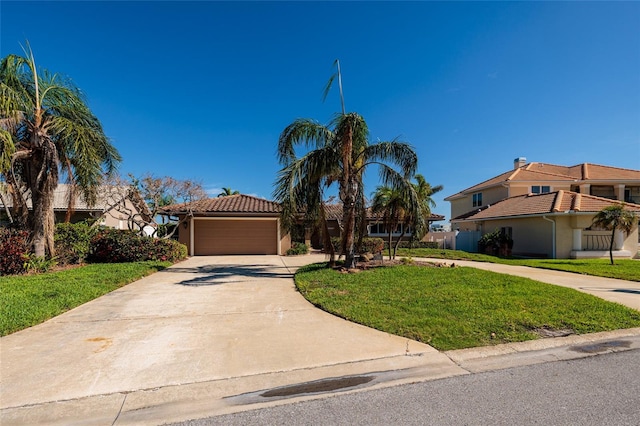 208 Bath Club Blvd N, North Redington Beach, FL 33708 - view of front facade with driveway, a front lawn, an attached garage, a tiled roof, and stucco siding