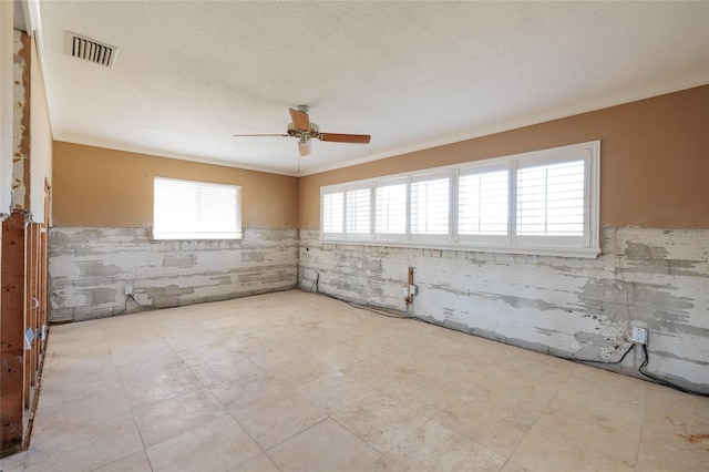 208 Bath Club Blvd N, North Redington Beach, FL 33708 - empty room with a ceiling fan, wainscoting, and crown molding
