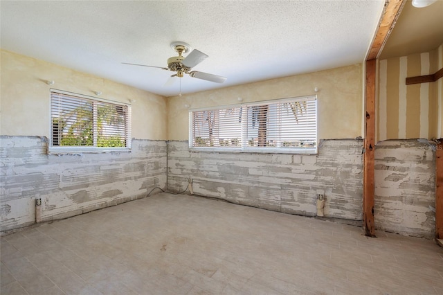 208 Bath Club Blvd N, North Redington Beach, FL 33708 - empty room featuring a ceiling fan and a textured ceiling