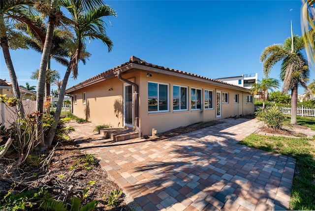 208 Bath Club Blvd N, North Redington Beach, FL 33708 - view of front of house featuring stucco siding, a patio area, and a tile roof