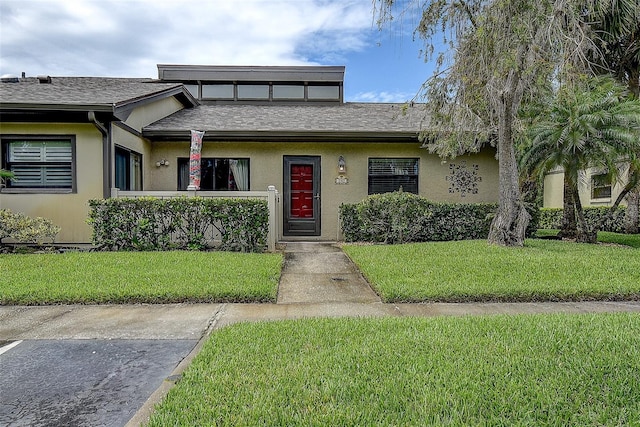 140 Dale Pl, Oldsmar, FL 34677 - view of property featuring stucco siding, a front yard, and a shingled roof