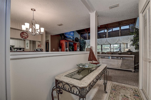 140 Dale Pl, Oldsmar, FL 34677 - hall with a textured ceiling, a chandelier, and tile patterned floors