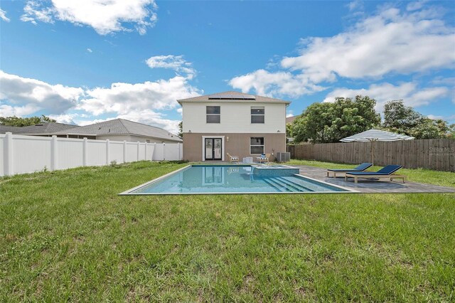 11130 Summer Star Dr, Riverview, FL 33579 - back of house featuring solar panels, a patio, a fenced backyard, and a pool with connected hot tub