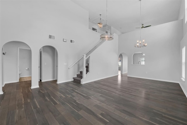 11130 Summer Star Dr, Riverview, FL 33579 - unfurnished living room with a high ceiling, stairs, dark wood-style floors, arched walkways, and a ceiling fan