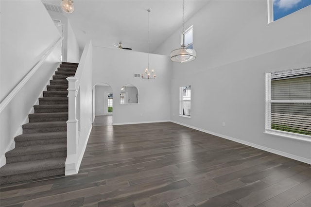 11130 Summer Star Dr, Riverview, FL 33579 - unfurnished living room with a chandelier, plenty of natural light, a high ceiling, stairway, and arched walkways