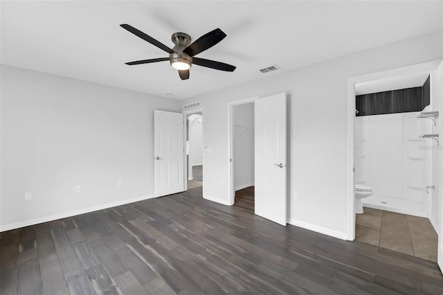 11130 Summer Star Dr, Riverview, FL 33579 - unfurnished bedroom featuring dark wood-type flooring, ensuite bathroom, a spacious closet, ceiling fan, and a closet