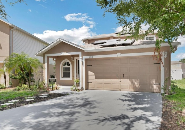 11130 Summer Star Dr, Riverview, FL 33579 - view of front facade featuring concrete driveway, stucco siding, solar panels, and a garage