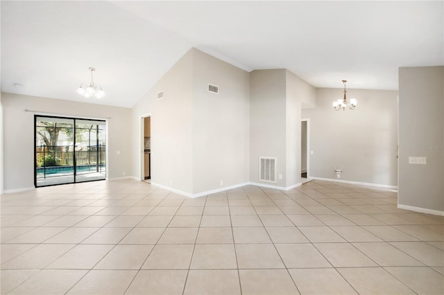 9807 Stephenson Dr, New Port Richey, FL 34655 - spare room with a chandelier, vaulted ceiling, and light tile patterned floors