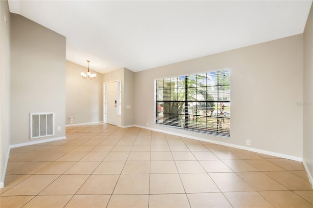 9807 Stephenson Dr, New Port Richey, FL 34655 - empty room with lofted ceiling, a chandelier, and light tile patterned floors