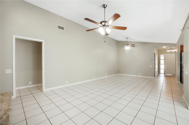 9807 Stephenson Dr, New Port Richey, FL 34655 - spare room with vaulted ceiling, ceiling fan, a chandelier, and light tile patterned flooring