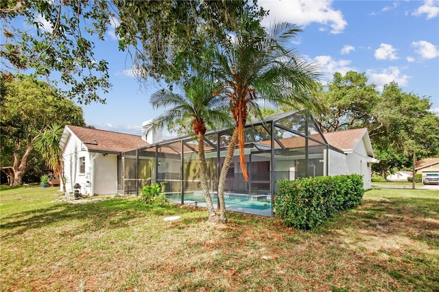 9807 Stephenson Dr, New Port Richey, FL 34655 - rear view of property featuring a yard, an outdoor pool, and glass enclosure