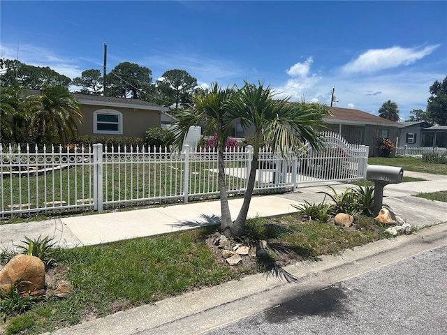 5106 Gateway Dr, Tampa, FL 33615 - view of property hidden behind natural elements with a fenced front yard and stucco siding