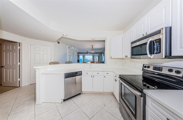 16600 Gulf Blvd Unit 437, North Redington Beach, FL 33708 - kitchen with stainless steel appliances, light tile patterned flooring, white cabinets, light countertops, and recessed lighting