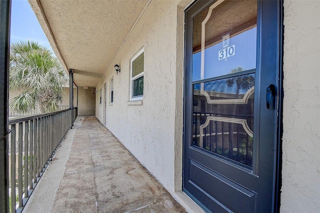 11485 Oakhurst Rd Unit 310, Largo, FL 33771 - view of exterior entry featuring stucco siding and a balcony