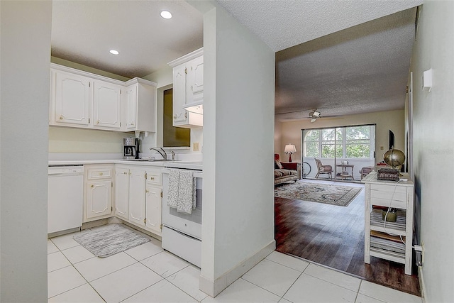 11485 Oakhurst Rd Unit 310, Largo, FL 33771 - kitchen with white appliances, light countertops, white cabinets, a textured ceiling, and ceiling fan