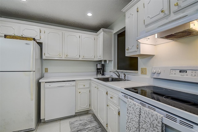 11485 Oakhurst Rd Unit 310, Largo, FL 33771 - kitchen featuring white appliances, under cabinet range hood, white cabinets, a textured ceiling, and recessed lighting