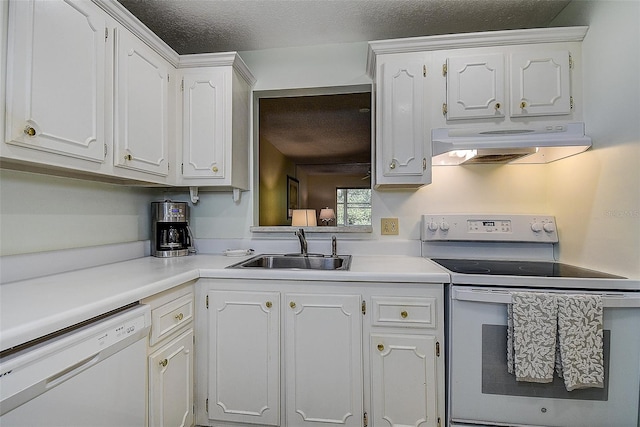 11485 Oakhurst Rd Unit 310, Largo, FL 33771 - kitchen featuring range hood, white appliances, white cabinets, a textured ceiling, and light countertops