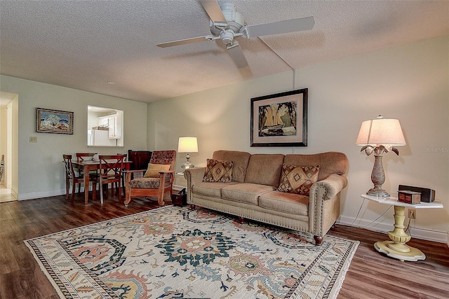 11485 Oakhurst Rd Unit 310, Largo, FL 33771 - living room featuring a ceiling fan, wood finished floors, and a textured ceiling