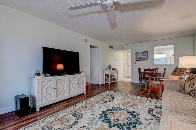 11485 Oakhurst Rd Unit 310, Largo, FL 33771 - living area with dark wood-style flooring, a ceiling fan, and a textured ceiling