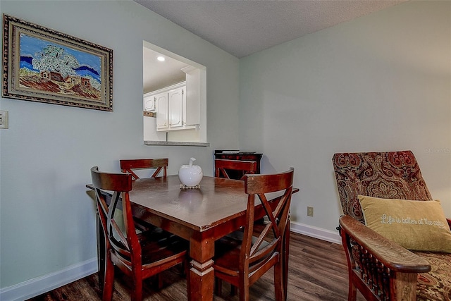 11485 Oakhurst Rd Unit 310, Largo, FL 33771 - dining area with dark wood-type flooring and a textured ceiling