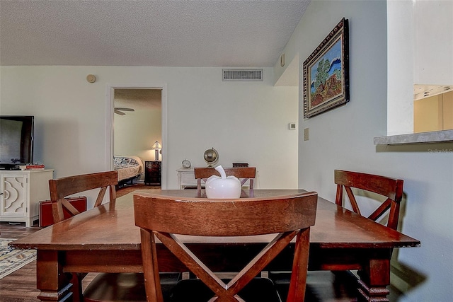 11485 Oakhurst Rd Unit 310, Largo, FL 33771 - dining space with wood finished floors and a textured ceiling