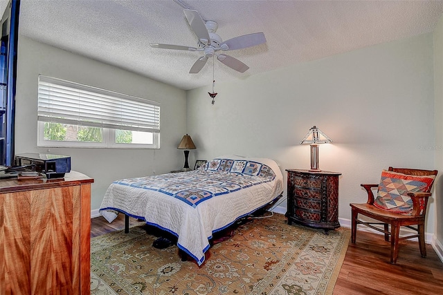 11485 Oakhurst Rd Unit 310, Largo, FL 33771 - bedroom with wood finished floors, a textured ceiling, and ceiling fan
