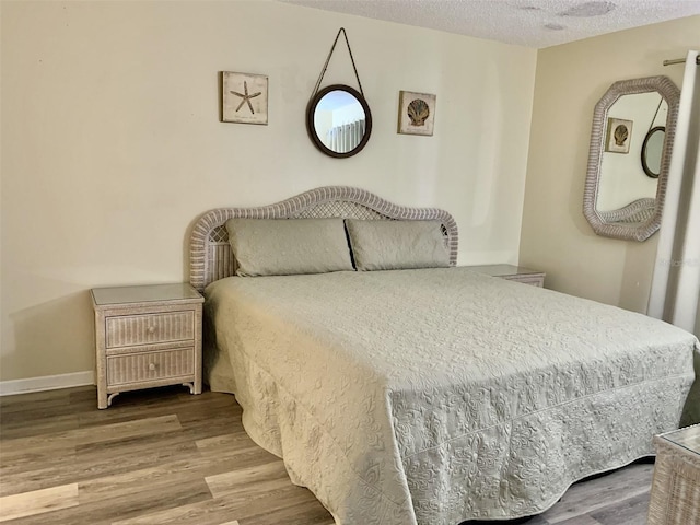4712 Marine Pkwy Unit 203, New Port Richey, FL 34652 - bedroom featuring wood finished floors and a textured ceiling
