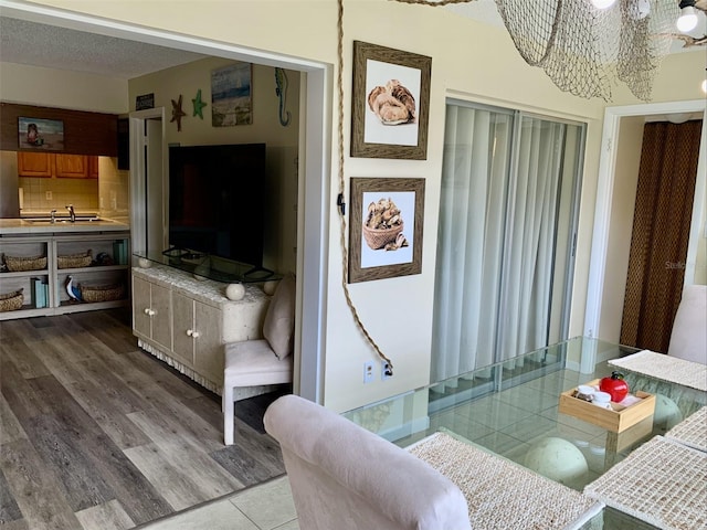 4712 Marine Pkwy Unit 203, New Port Richey, FL 34652 - living room with a chandelier and wood finished floors