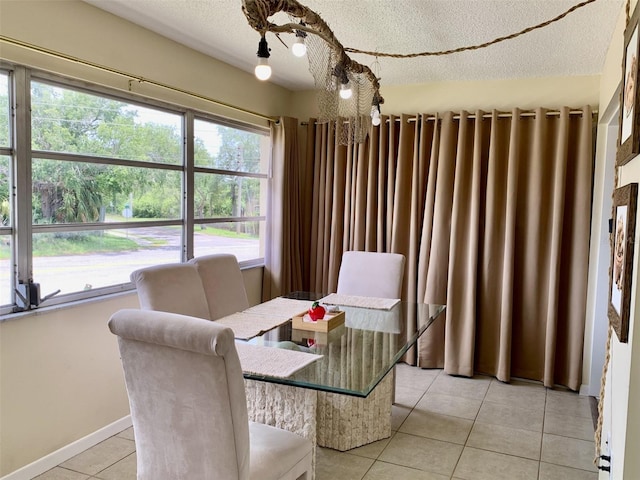 4712 Marine Pkwy Unit 203, New Port Richey, FL 34652 - dining room featuring light tile patterned flooring and a textured ceiling