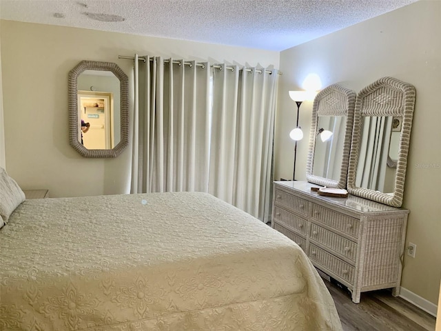 4712 Marine Pkwy Unit 203, New Port Richey, FL 34652 - bedroom featuring wood finished floors and a textured ceiling