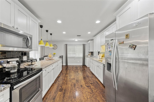 602 Hillpoint Way, Brandon, FL 33510 - kitchen with appliances with stainless steel finishes, recessed lighting, white cabinets, tasteful backsplash, and light stone counters
