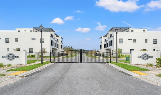 6206 64th Way N, Pinellas Park, FL 33781 - view of asphalt road featuring sidewalks, street lighting, a gate, and curbs